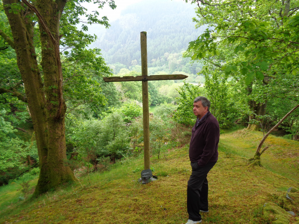 Photo of Mike next to a cross